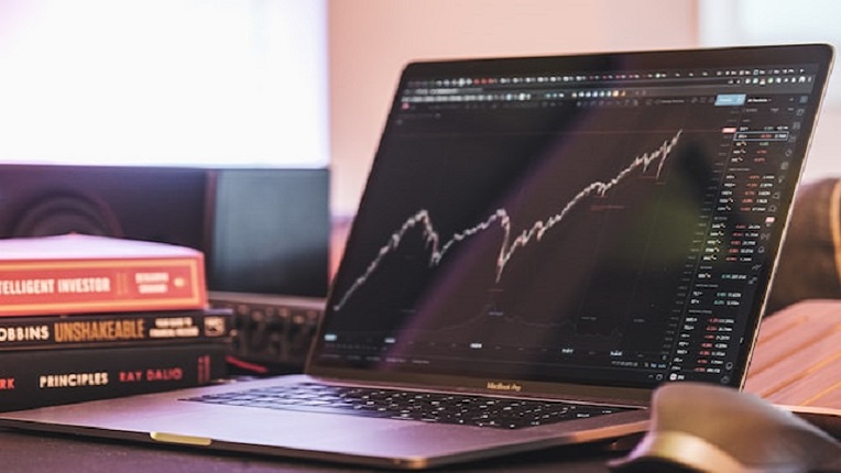 Laptop depicting a stock market graph on screen