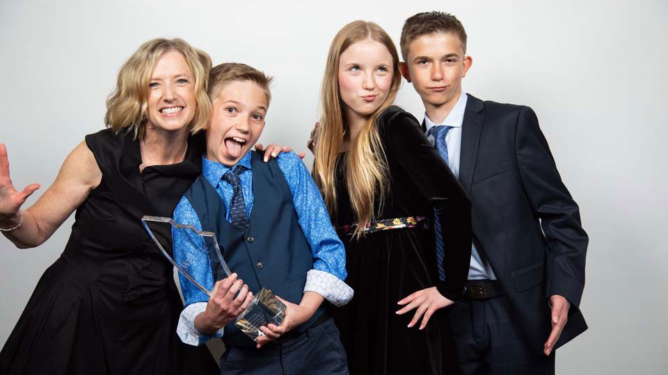 Leah Schmidt and her children holding the award.